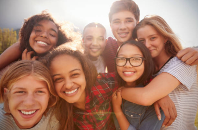 A group of teen friends smiling